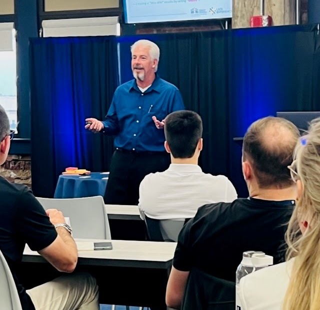 Dave Payne leading a live sales training session for a group of professionals